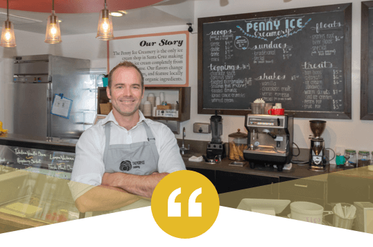 Zach Davis standing in Penny Ice Creamery with his arms crossed